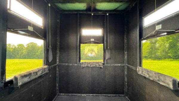 Interior of a Hunting Blind with Windows Overlooking Green Field