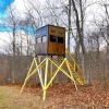 Elevated Wooden Hunting Blind in Forested Area with Yellow Support Beams